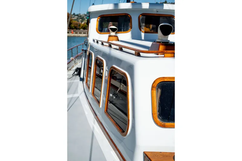 Slide: The Image of 1981 Thackwray Motorsailor yacht with wooden trim and sleek white exterior on a sunny day. - 30