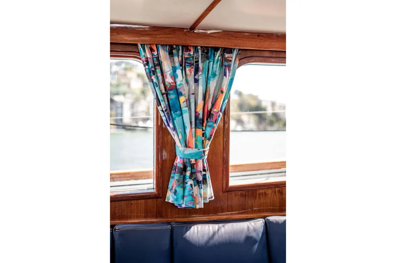 Slide: The Image of Colorful curtains on a 1981 Thackwray Motorsailor yacht, with wooden interior and scenic view. - 60