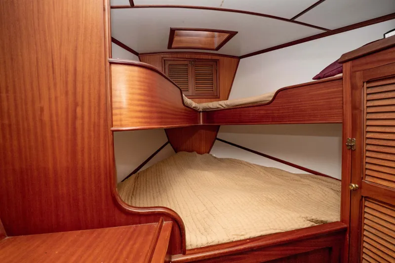 Slide: The Image of Cozy wooden cabin interior of 1981 Thackwray Motorsailor with bunk beds and storage. - 89