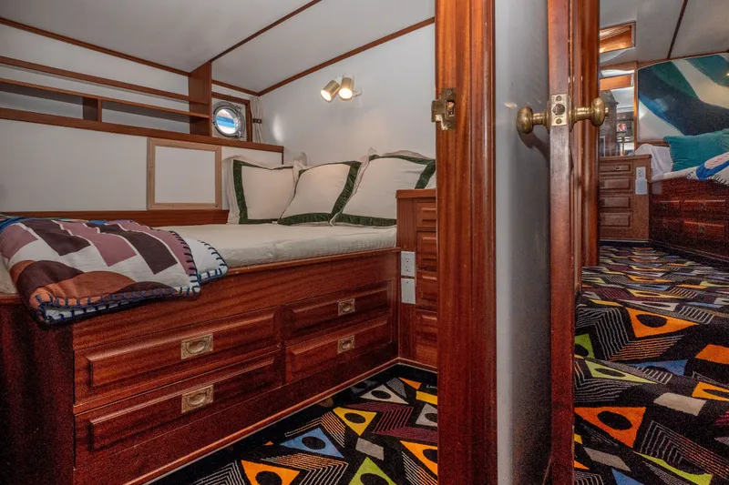 Slide: The Image of Cozy cabin interior of 1981 Thackwray Motorsailor with wooden furnishings and colorful carpet. - 113