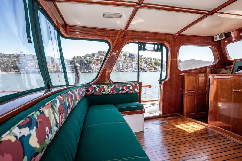 Slide: The Image of Interior of 1981 Thackwray Motorsailor with wooden finish and floral upholstery, overlooking scenic waterfront. - 76