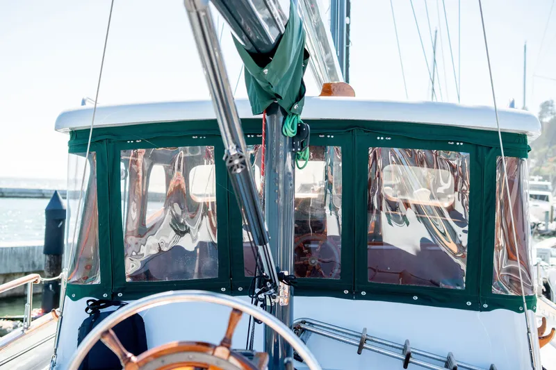 Slide: The Image of 1981 Thackwray Motorsailor with green canopy, docked at a marina. - 29