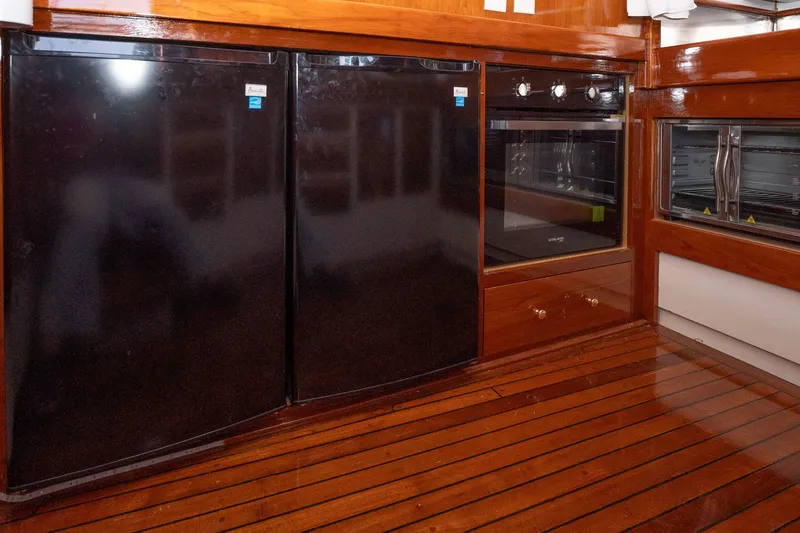 Slide: The Image of Interior of 1981 Thackwray Motorsailor with wooden flooring, black appliances, and modern oven. - 93