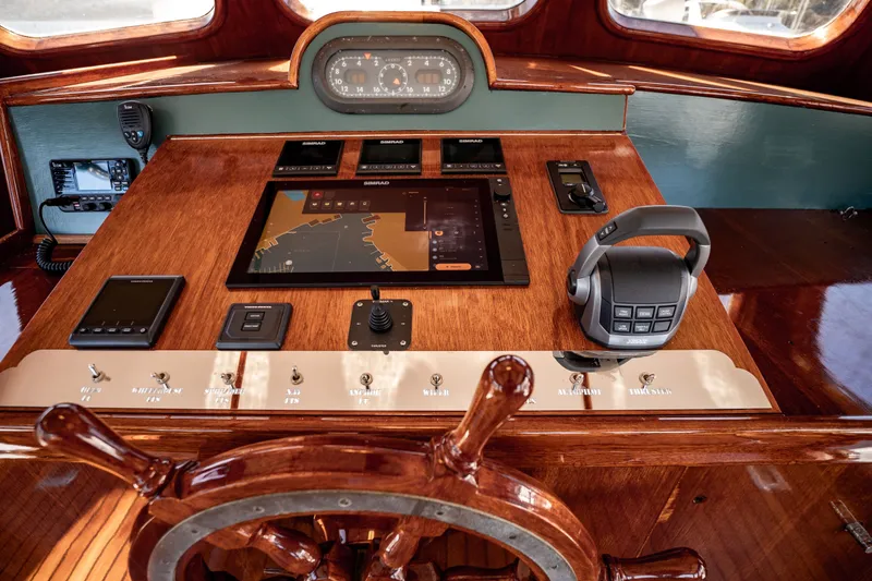 Slide: The Image of 1981 Thackwray Motorsailor helm with navigation equipment and classic wooden steering wheel. - 68