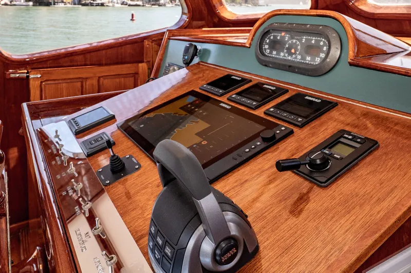 Slide: The Image of Control panel of a 1981 Thackwray Motorsailor with navigation instruments and wooden finish. - 70