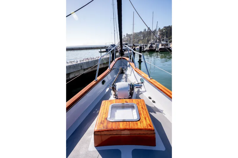 Slide: The Image of 1981 Thackwray Motorsailor docked at marina, showcasing polished wood and sleek design. - 18