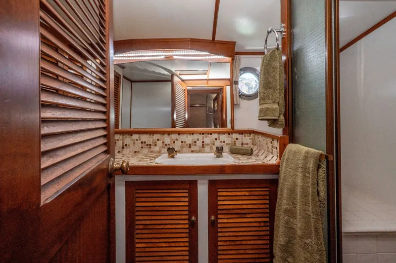 Slide: The Image of Luxurious 1981 Thackwray Motorsailor bathroom with wooden accents and elegant tile backsplash. - 109