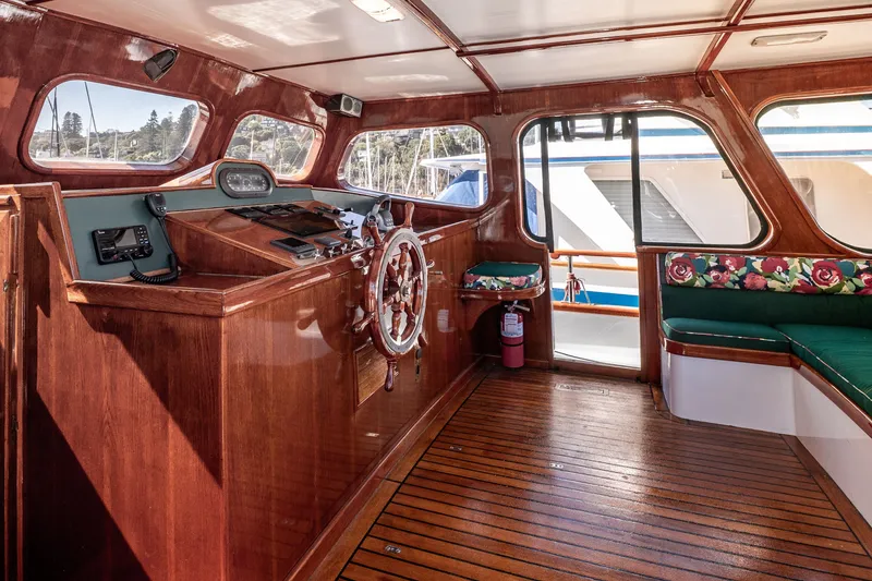 Slide: The Image of Interior of 1981 Thackwray Motorsailor with wooden helm, floral seating, and nautical decor. - 72