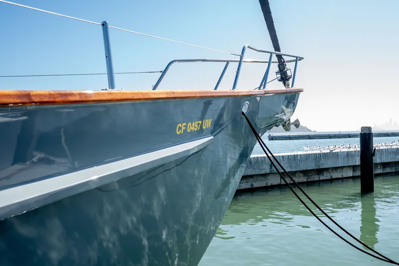 Slide: The Image of 1981 Thackwray Motorsailor docked, reflecting sunlight on calm water. - 25