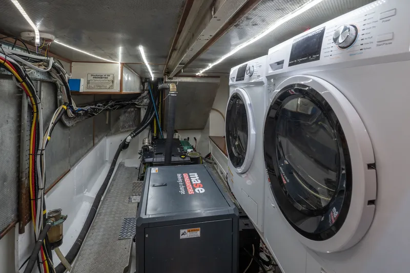 Slide: The Image of Engine room of 1981 Thackwray Motorsailor with washer, dryer, and generator. - 92