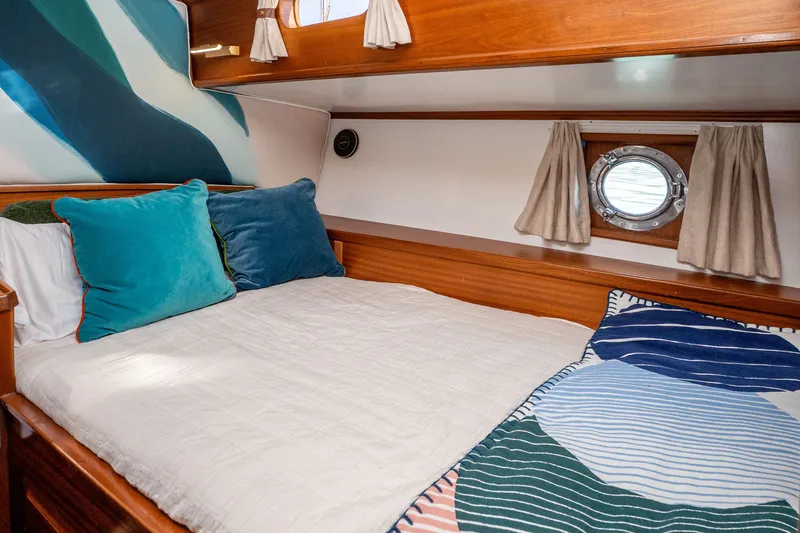 Slide: The Image of Cozy cabin interior of 1981 Thackwray Motorsailor with colorful pillows and nautical decor. - 98