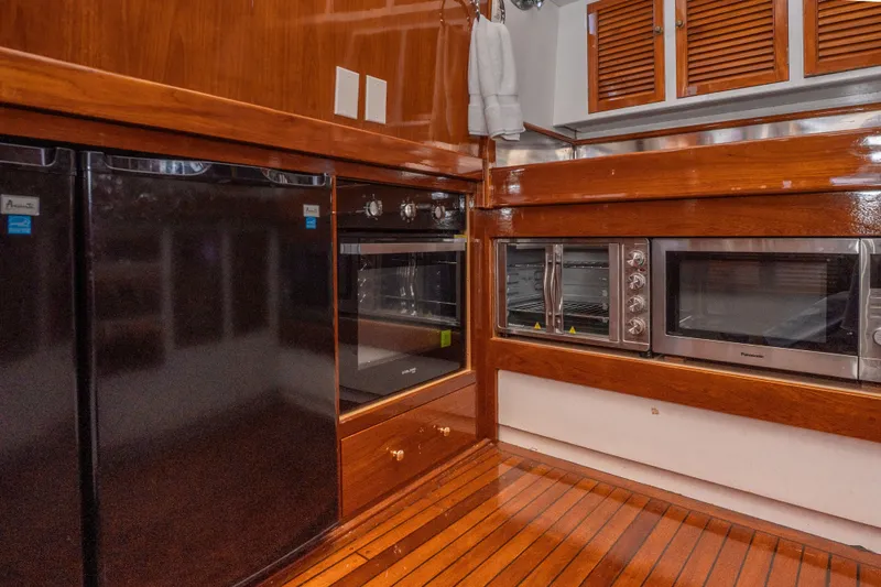 Slide: The Image of Wood-paneled kitchen in 1981 Thackwray Motorsailor with modern appliances and sleek design. - 94