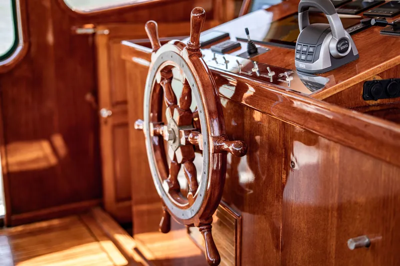 Slide: The Image of Wooden helm of 1981 Thackwray Motorsailor with polished finish and control panel. - 59