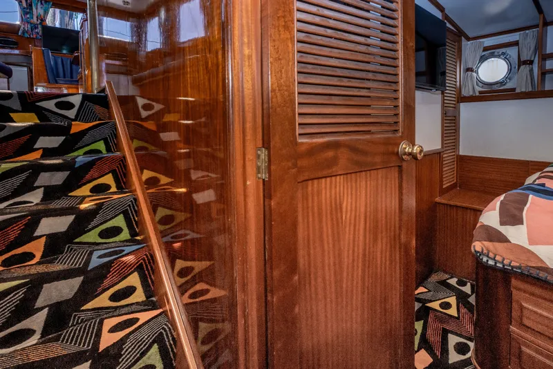 Slide: The Image of Interior of 1981 Thackwray Motorsailor with colorful carpeted stairs and wooden paneling. - 107