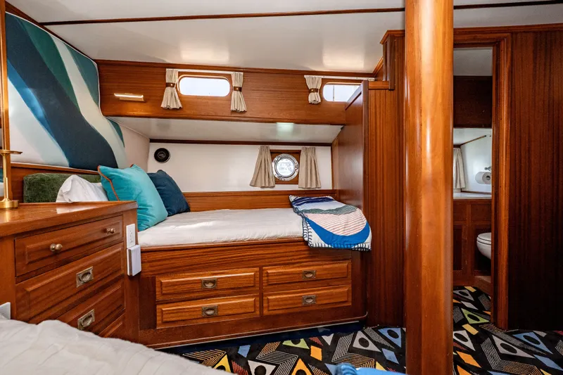 Slide: The Image of Cozy 1981 Thackwray Motorsailor cabin with wooden interior and colorful decor. - 100