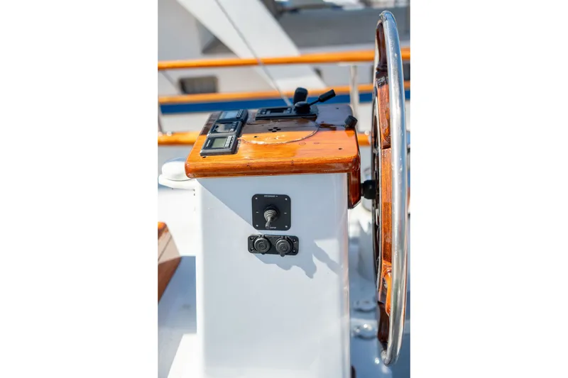 Slide: The Image of 1981 Thackwray Motorsailor helm with wooden wheel and control panel. - 38