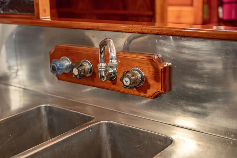 Slide: The Image of Vintage Thackwray Motorsailor 1981 kitchen sink with wooden faucet panel and dual basins. - 65