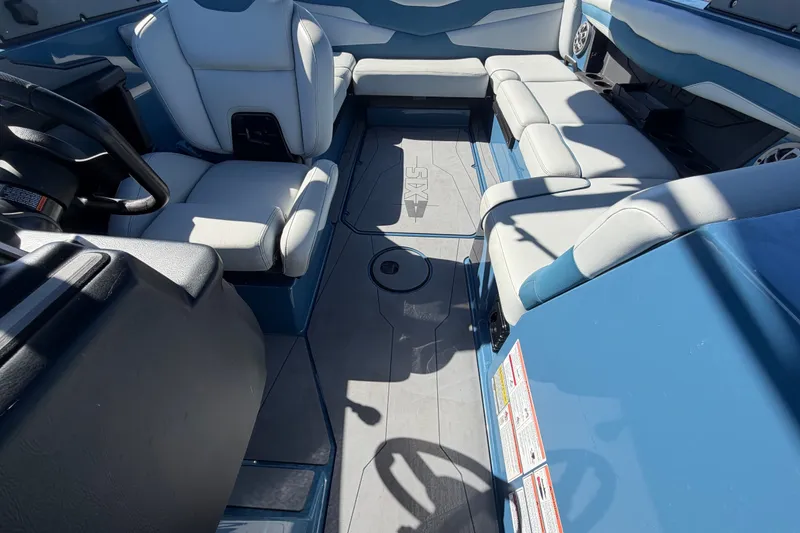 Slide: The Image of Interior of 2023 Axis T220 boat with blue and white seating arrangement. - 53