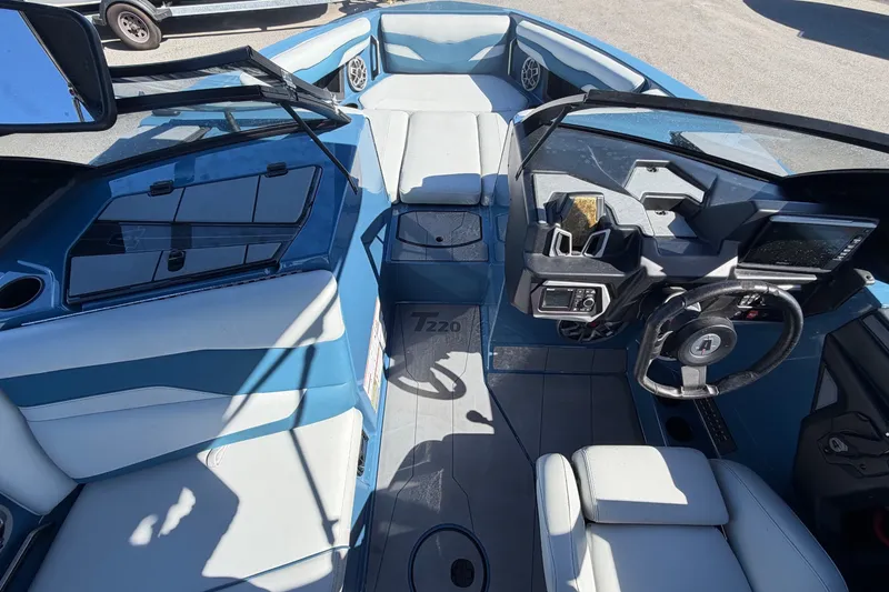 Slide: The Image of Interior view of a 2023 Axis T220 boat with blue and gray seating. - 28