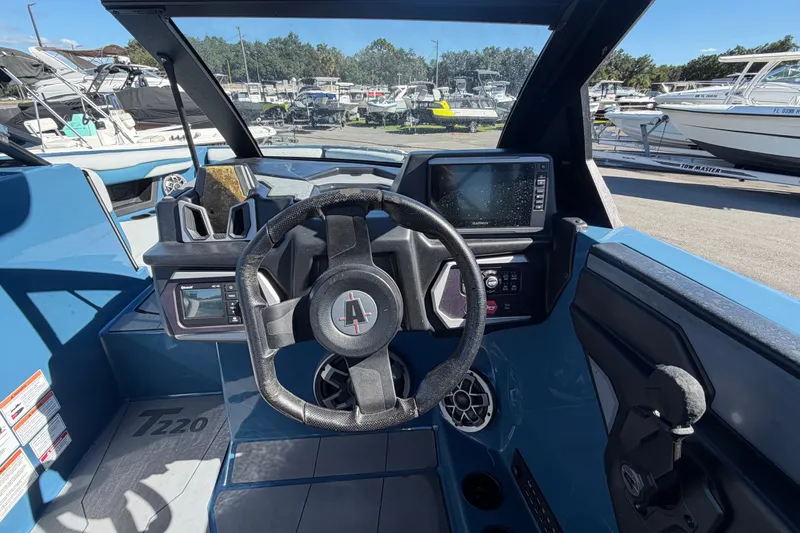 Slide: The Image of 2023 Axis T220 boat dashboard with steering wheel and navigation display. - 31