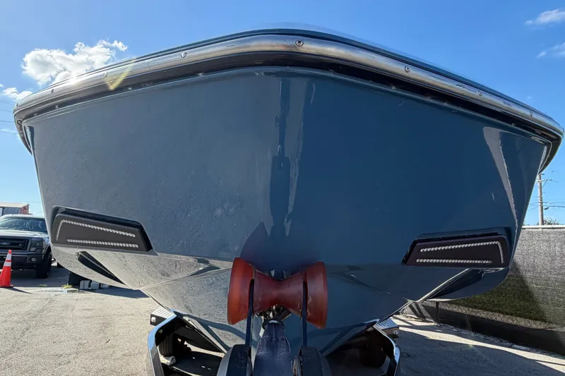 Slide: The Image of 2023 Axis T220 boat front view under clear blue sky. - 11