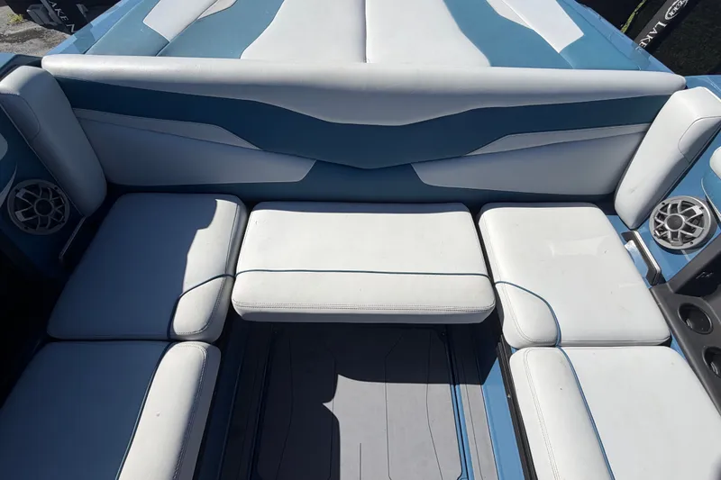 Slide: The Image of 2023 Axis T220 boat interior with white and blue cushioned seating. - 62