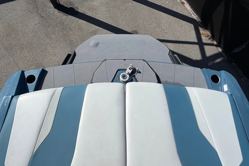 Slide: The Image of 2023 Axis T220 boat interior with blue and white seating, viewed from above. - 73