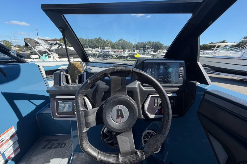 Slide: The Image of 2023 Axis T220 boat dashboard with steering wheel and digital display. - 32