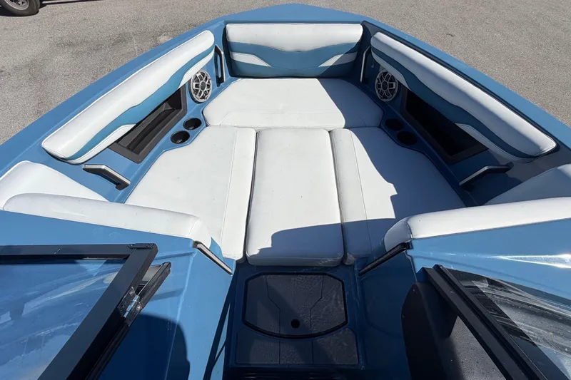 Slide: The Image of The image shows the bow of a 2023 Axis T220 boat with blue and white upholstery. - 42