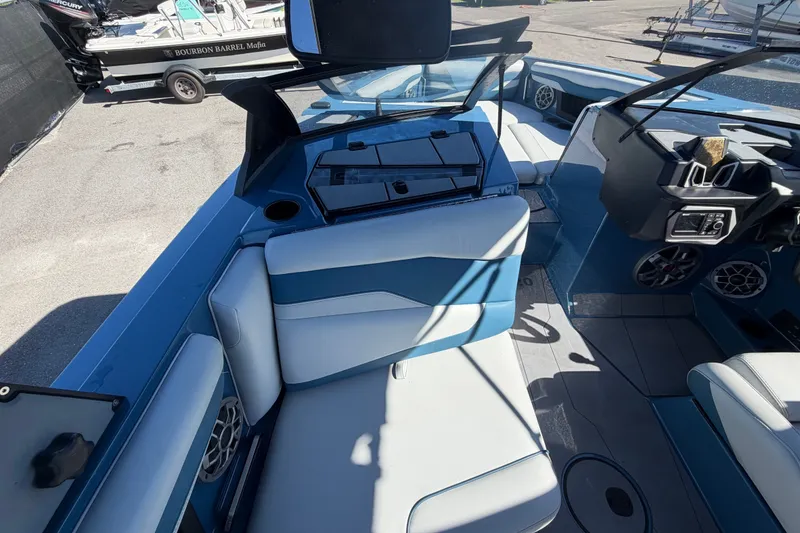 Slide: The Image of 2023 Axis T220 boat interior with blue and white seating, dashboard, and speakers. - 20