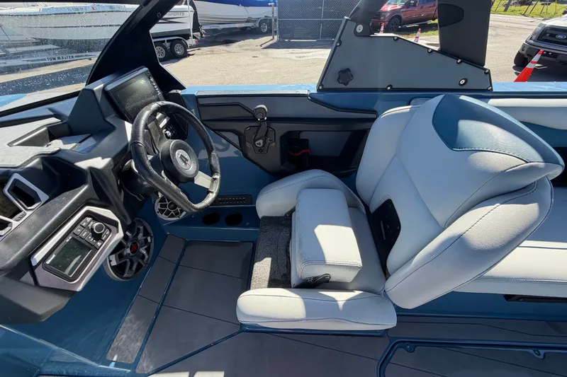 Slide: The Image of 2023 Axis T220 boat interior with steering wheel and comfortable seating. - 30