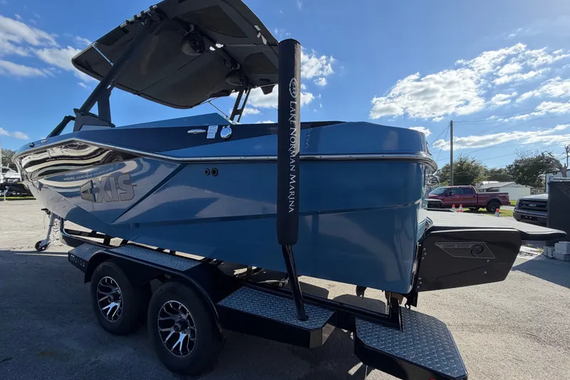 Slide: The Image of 2023 Axis T220 boat on trailer under clear blue sky. - 8