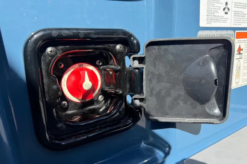Slide: The Image of Red switch on a 2023 Axis T220 boat, with open protective cover. - 27