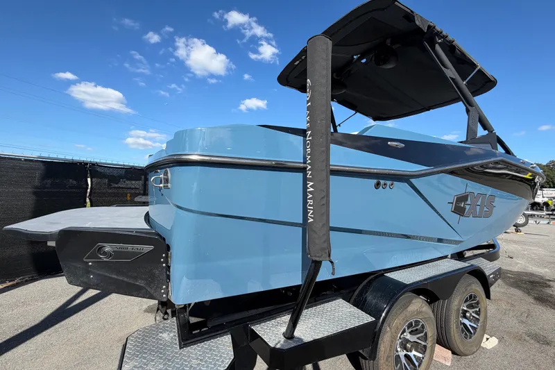 Slide: The Image of 2023 Axis T220 boat on trailer under clear blue sky. - 3