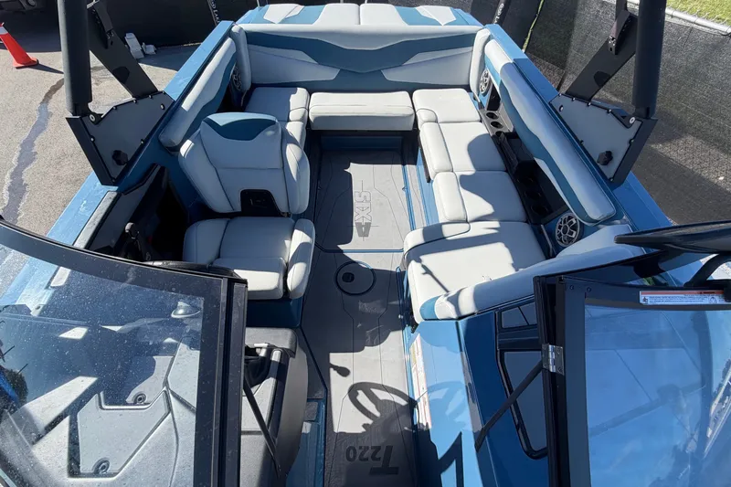 Slide: The Image of Interior view of a 2023 Axis T220 boat with gray and blue seating. - 52