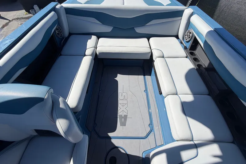 Slide: The Image of 2023 Axis T220 boat interior with blue and white seating and integrated speakers. - 55
