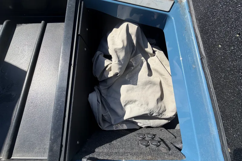 Slide: The Image of Storage compartment in 2023 Axis T220 boat with folded fabric inside. - 72
