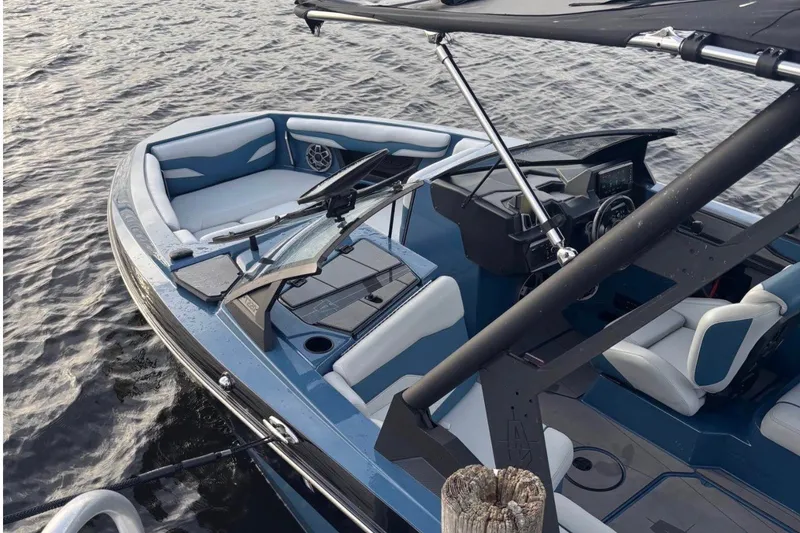 Slide: The Image of 2023 Axis T220 boat with sleek blue interior and modern design on the water. - 6