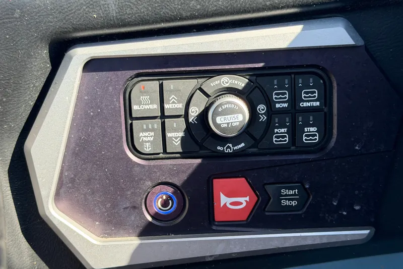 Slide: The Image of Control panel of a 2023 Axis T220 boat with various function buttons. - 36