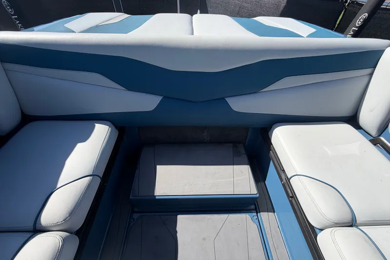 Slide: The Image of Interior seating of 2023 Axis T220 boat, featuring blue and white upholstery. - 64