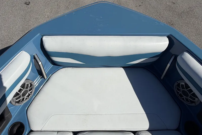 Slide: The Image of The image shows the bow of a 2023 Axis T220 boat with blue and white upholstery. - 46