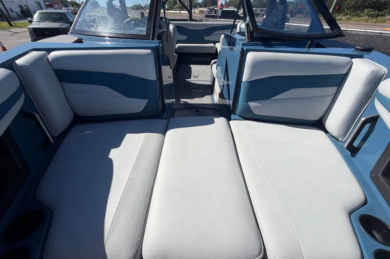 Slide: The Image of 2023 Axis T220 boat interior with blue and white seating, showcasing spacious design. - 50