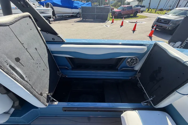 Slide: The Image of 2023 Axis T220 boat interior storage compartment with open seats and speaker. - 61