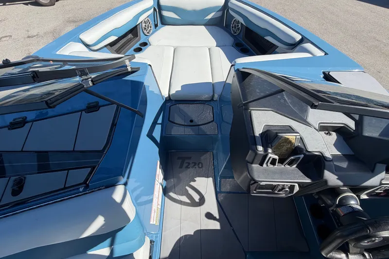 Slide: The Image of 2023 Axis T220 boat interior with blue and gray seating and dashboard. - 41