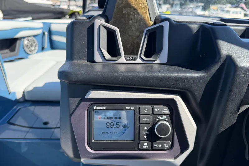 Slide: The Image of 2023 Axis T220 boat dashboard with Bluetooth radio displaying 99.5 MHz frequency. - 33