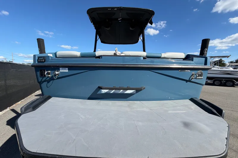 Slide: The Image of 2023 Axis T220 boat rear view with swim platform under clear blue sky. - 4