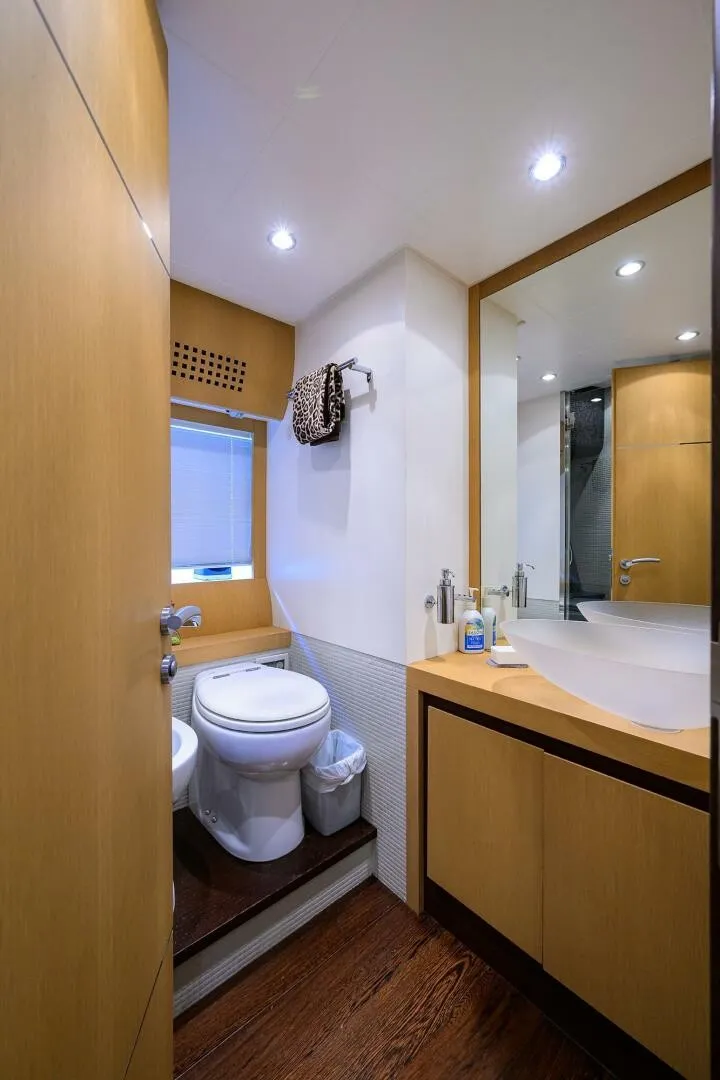 Slide: The Image of The image shows a modern yacht bathroom with wood paneling and sleek fixtures. - 30