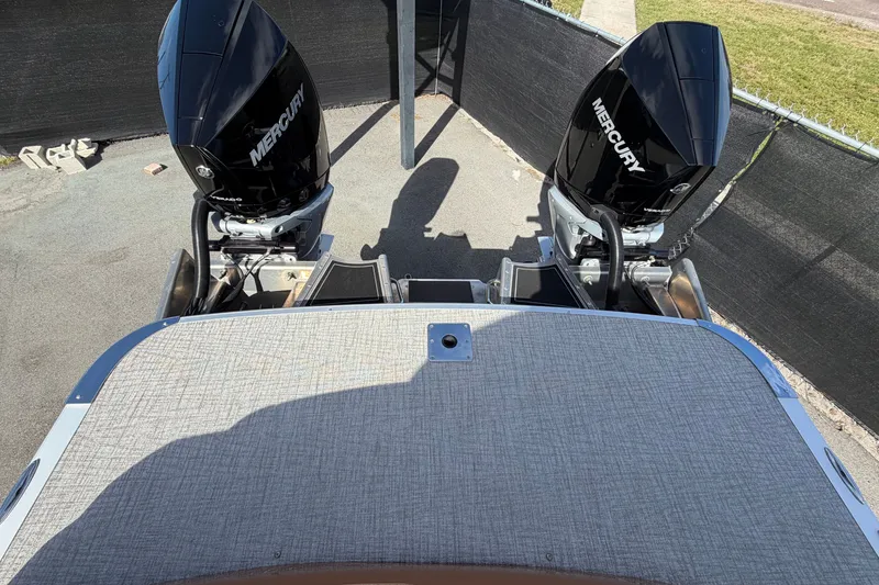 Slide: The Image of 2025 Avalon Excalibur LTD boat with dual Mercury outboard engines, rear view. - 91