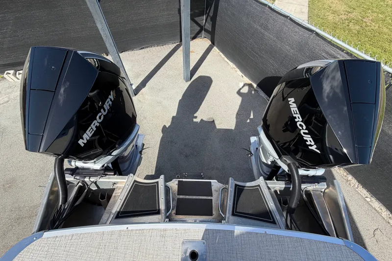 Slide: The Image of 2025 Avalon Excalibur LTD boat with dual Mercury outboard engines, rear view. - 93