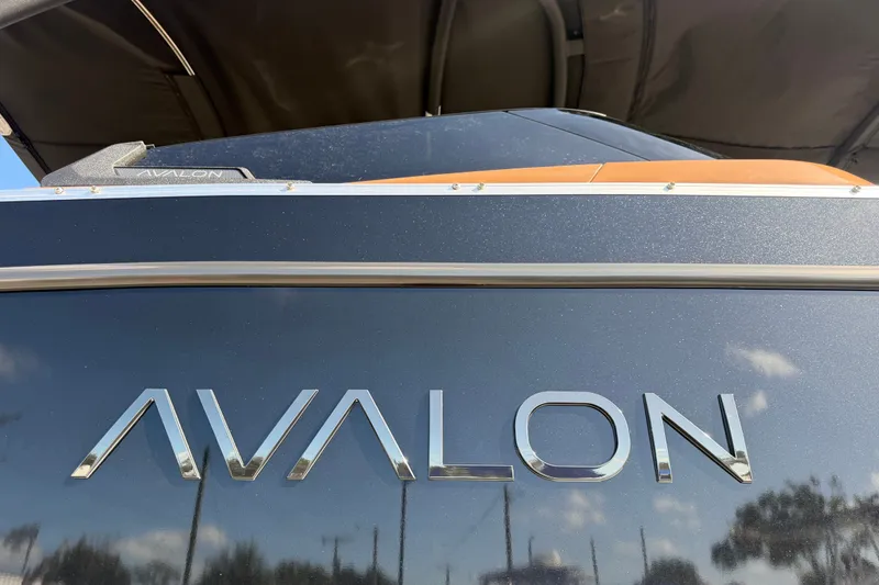Slide: The Image of 2025 Avalon Excalibur LTD Quad Lounge Windshield boat, close-up of logo and design. - 95
